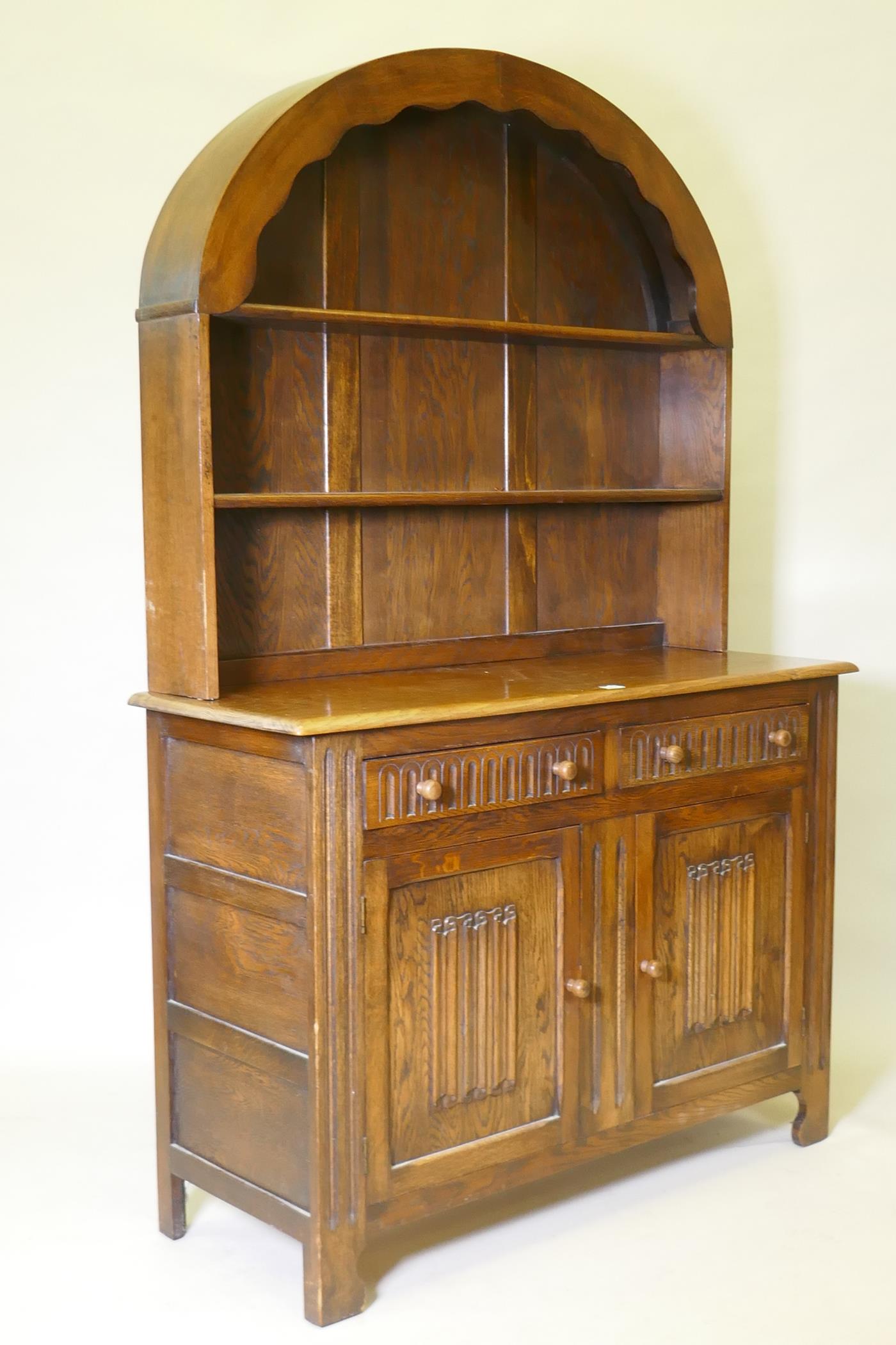A mid century oak dresser with dome shaped upper rack on a base of two drawers over two cupboards, - Image 2 of 3
