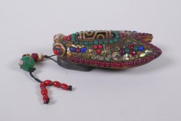 A Tibetan iron toggle in the form of a cicada, the wings set with a dzi bead, abalone, coral and