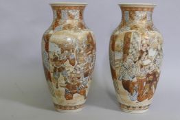 A pair of Meiji period Satsuma vases, decorated with warriors, 40cm high