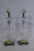 A pair of cut crystal glass table lamps on brass bases, 54cm high