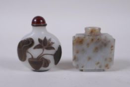 A Peking glass snuff bottle with carved decoration of a potted lotus flower, and a carved