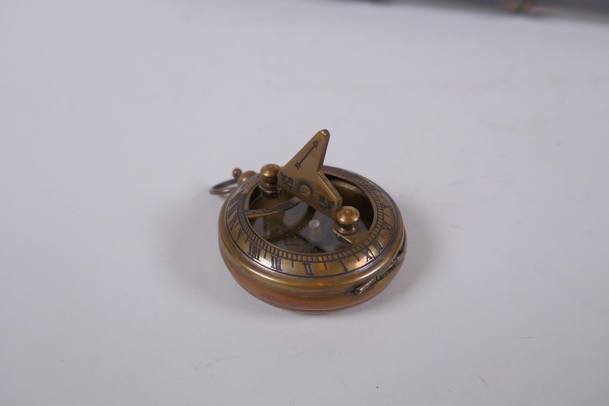 A reproduction brass fob watch sundial compass, and a four draw brass telescope, 39cm long extended - Image 2 of 5