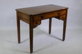 A C19th mahogany writing table, the central drawer with fitted compartments flanked by two