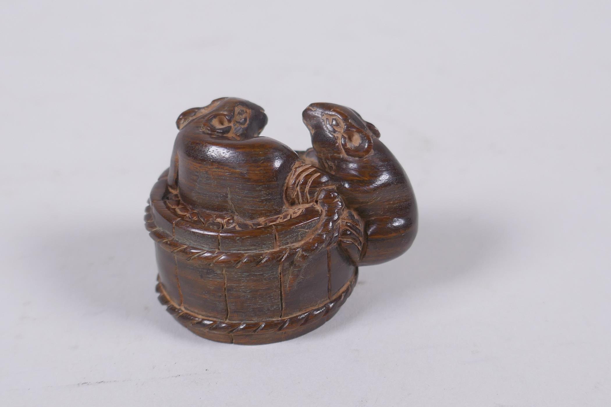 A Japanese carved hardwood okimono in the form of rats on a barrel, the base with inset signed - Image 3 of 4
