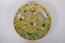 A Chinese late C19th Sancai glazed porcelain charger with incised butterfly and floral decoration,