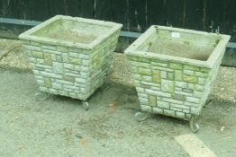A pair of concrete garden planters, 38cm high