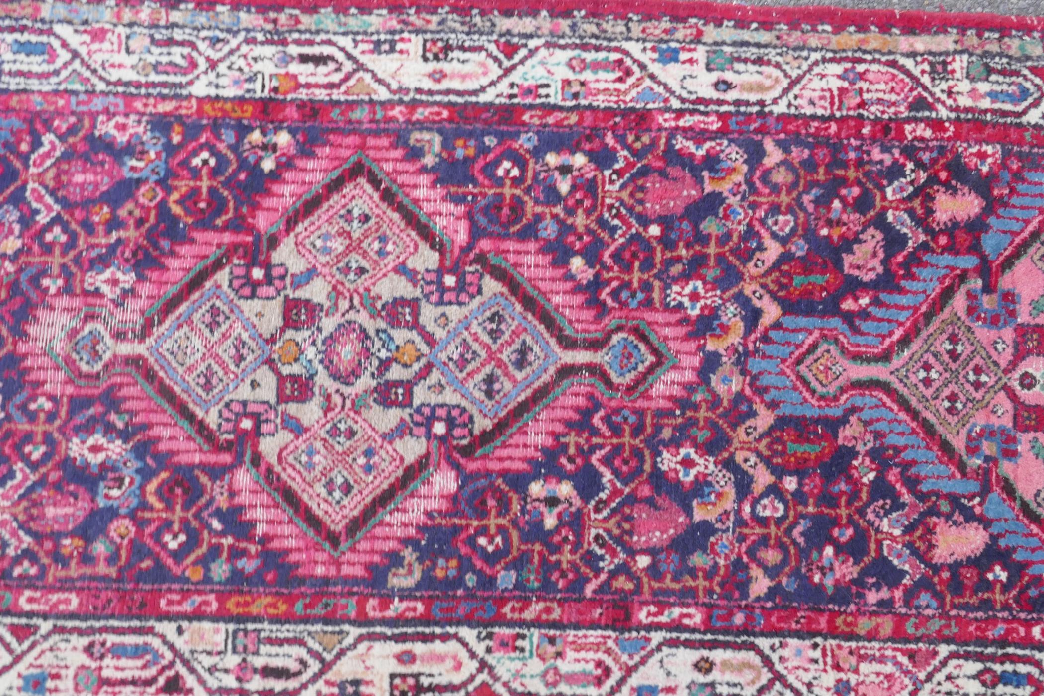 A Persian red ground wool runner with multi colour geometric medallion design, 85 x 340cm - Image 4 of 8