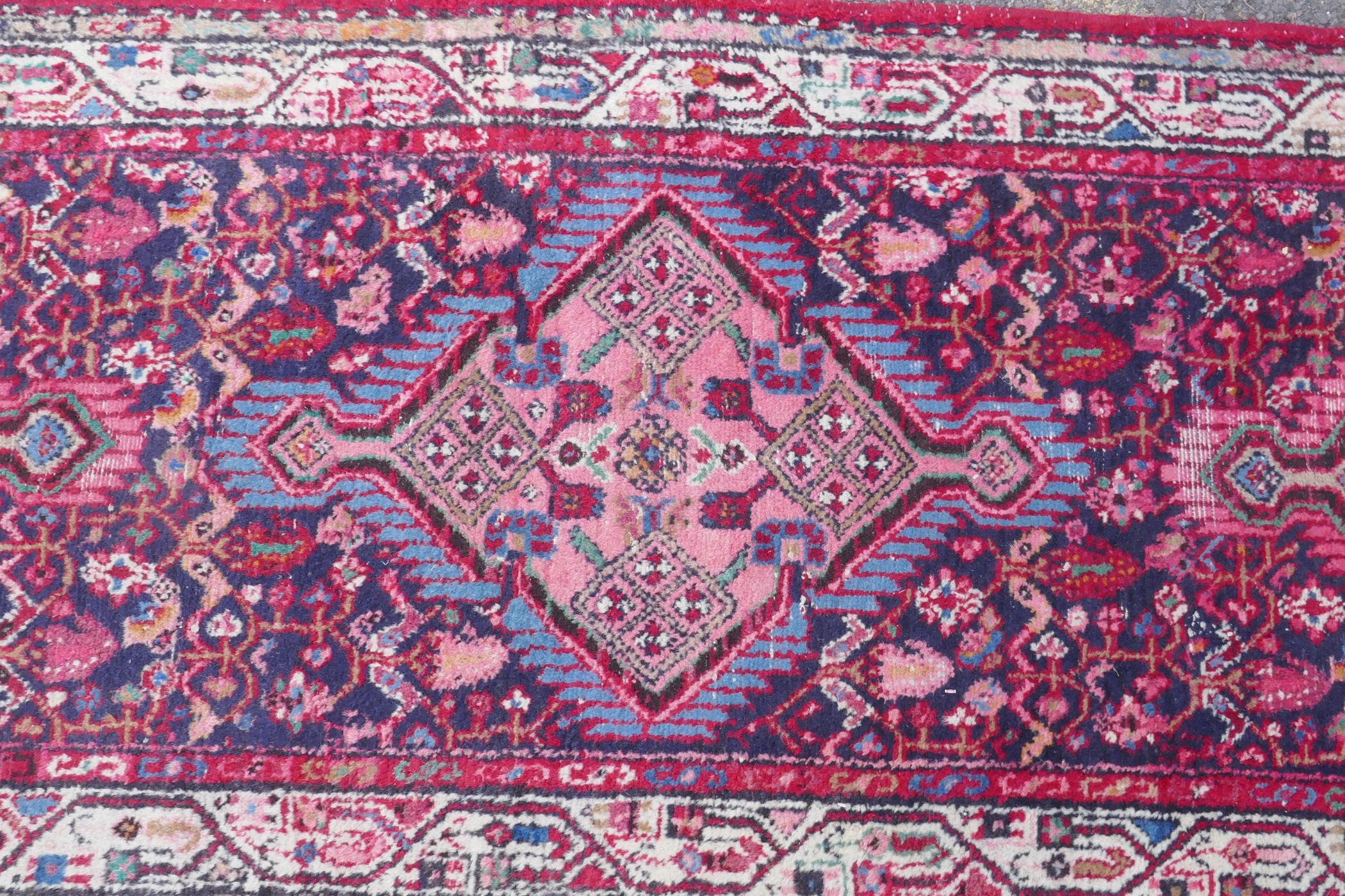 A Persian red ground wool runner with multi colour geometric medallion design, 85 x 340cm - Image 5 of 8