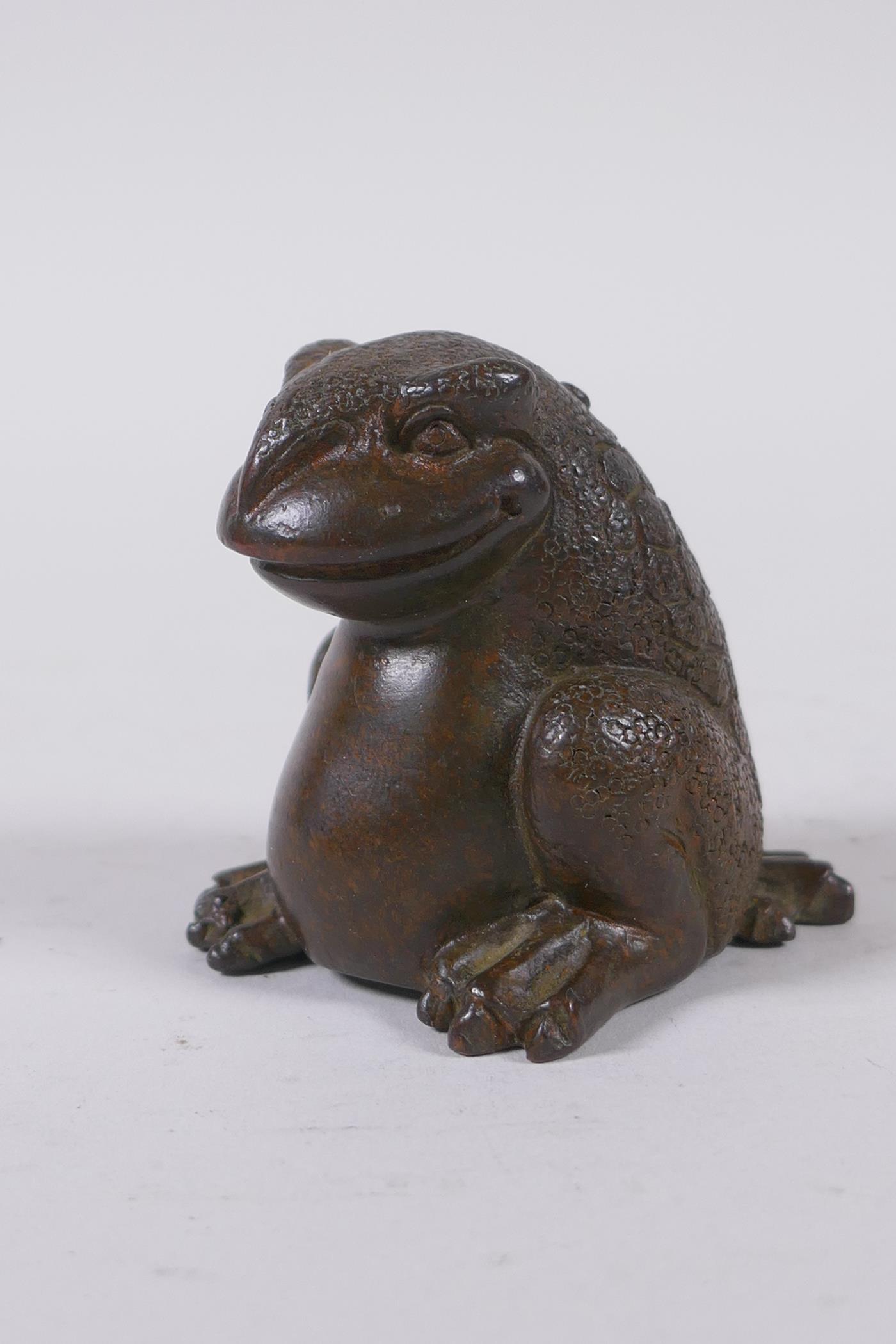 A Japanese style bronze okimono toad, impressed mark to base, 5cm high
