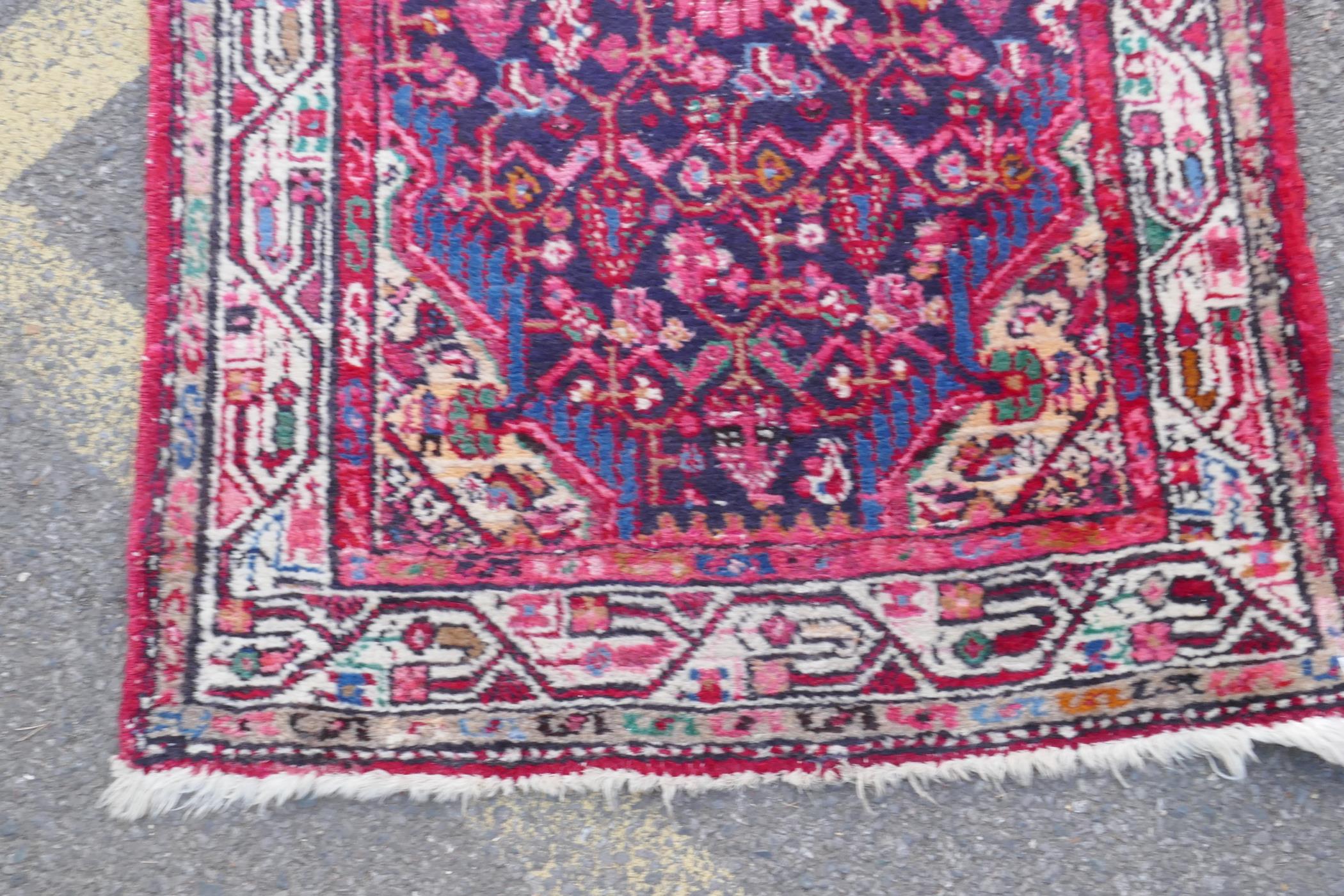 A Persian red ground wool runner with multi colour geometric medallion design, 85 x 340cm - Image 7 of 8