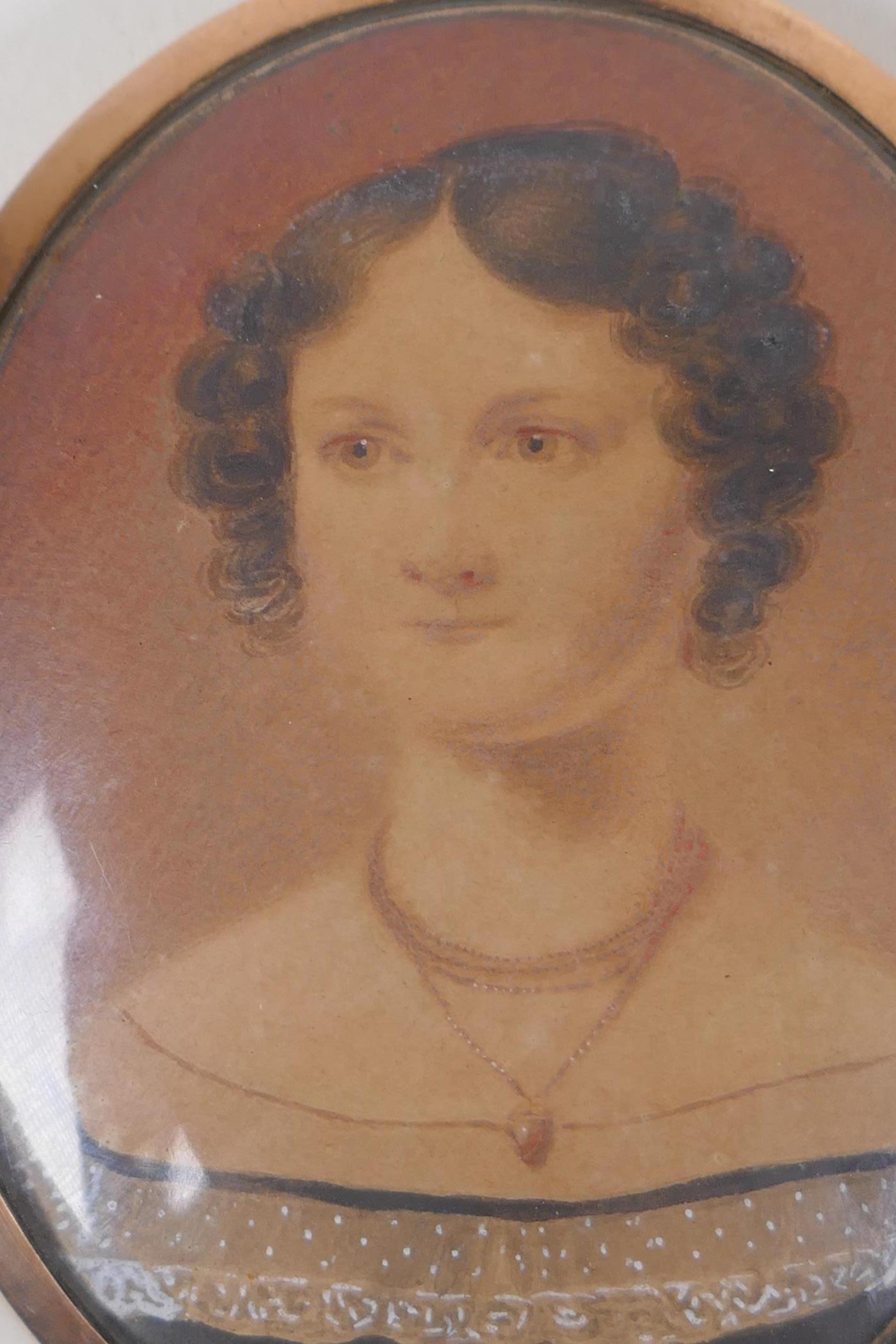 An early C19th miniature watercolour portrait of a lady in a rose metal pendant frame, with - Image 3 of 7