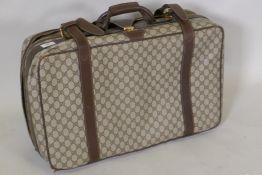 A Gucci suitcase with leather straps, and padlock in wallet, 62 x 40 x 20cm