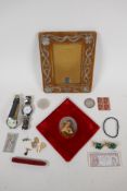 A miniature portrait on porcelain of a woman in a headdress, an Art Nouveau picture frame, and a