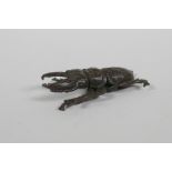 A Japanese style bronze okimono stag beetle, 6cm long