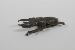 A Japanese style bronze okimono stag beetle, 6cm long