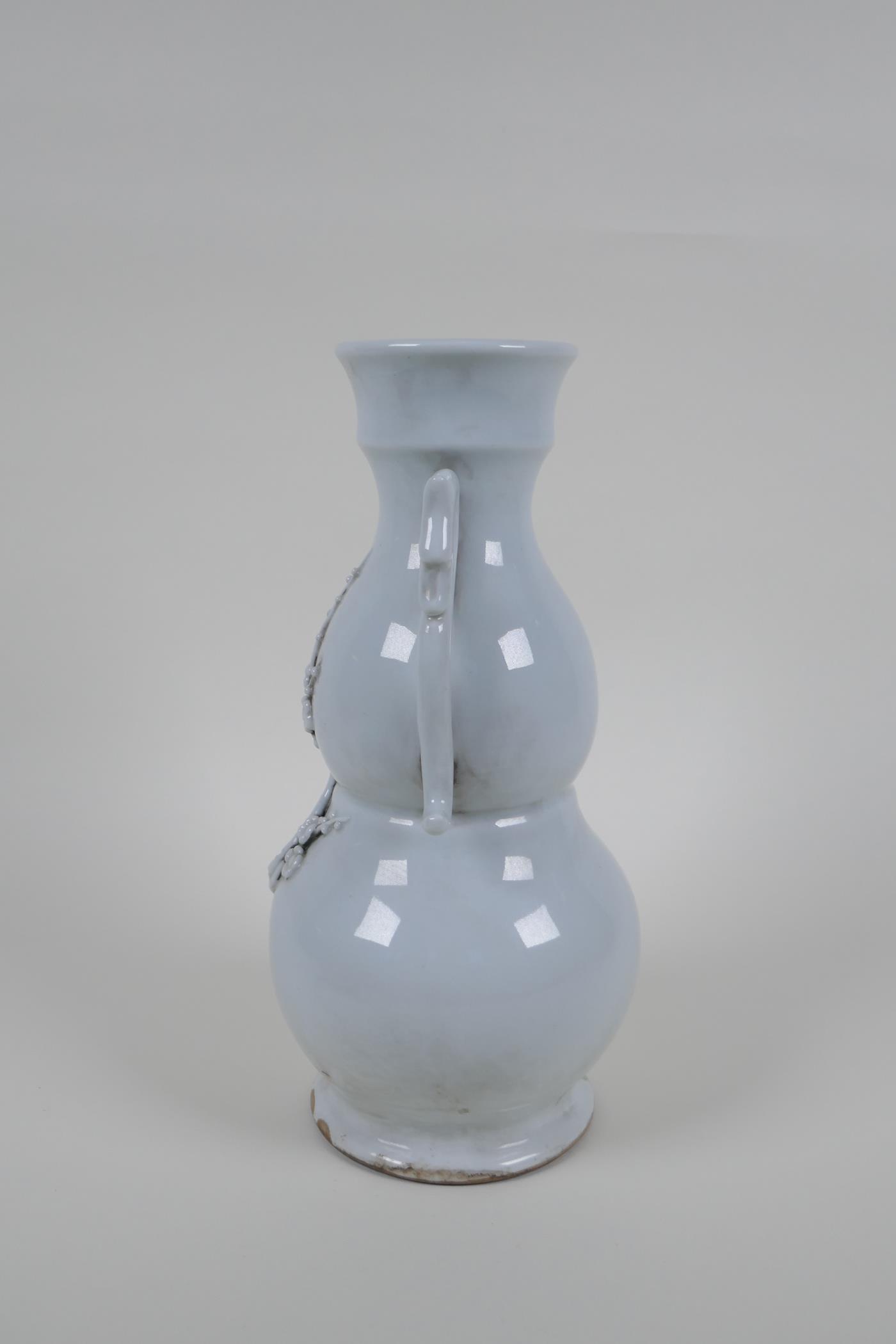 A blanc de chine porcelain two handled double gourd vase with raised prunus blossom decoration, - Image 2 of 5