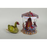 A vintage Chinese Gosling Goose clockwork tin toy, and a later German tin plate Merry-Go-Round,