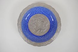 A Chinese blue glazed porcelain dish with a lobed rim and silvered details, decorated with lotus