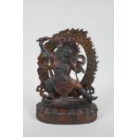 A Tibetan bronze figure of a wrathful deity, with the remnants of gilt patina, 24cm high