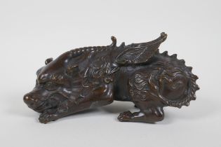 A Chinese filled bronze figure of a winged mythical creature, 20cm long