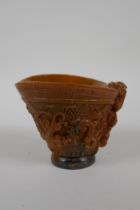 A Chinese faux horn libation cup decorated with kylin and auspicious symbols, seal mark to base,