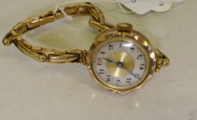 A lady's 9ct gold wristwatch and strap, dial 2.5cm wide