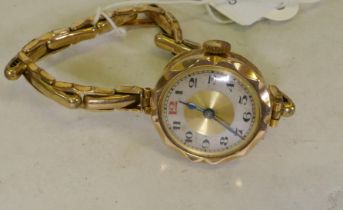 A lady's 9ct gold wristwatch and strap, dial 2.5cm wide
