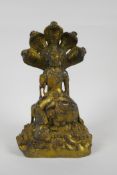 A Sino Tibetan gilt bronzed metal Buddha seated on a cobra throne, impressed Yongle 6 character