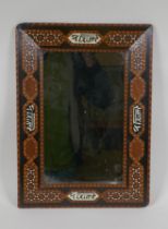 An antique Islamic marquetry inlaid mirror with script decoration, 30 x 43cm