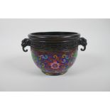 A Chinese bronze pot with cloisonne lotus flower decoration and two dragon mask handles, seal mark