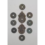 Eight Chinese facsimile (replica) bronze coins, and a pair of Chinese bronze medallions, 4 x 6cm