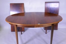 A Danish Gudme Mobelfabrik dining table with two leaves, raised on bolt on tapering supports, 100