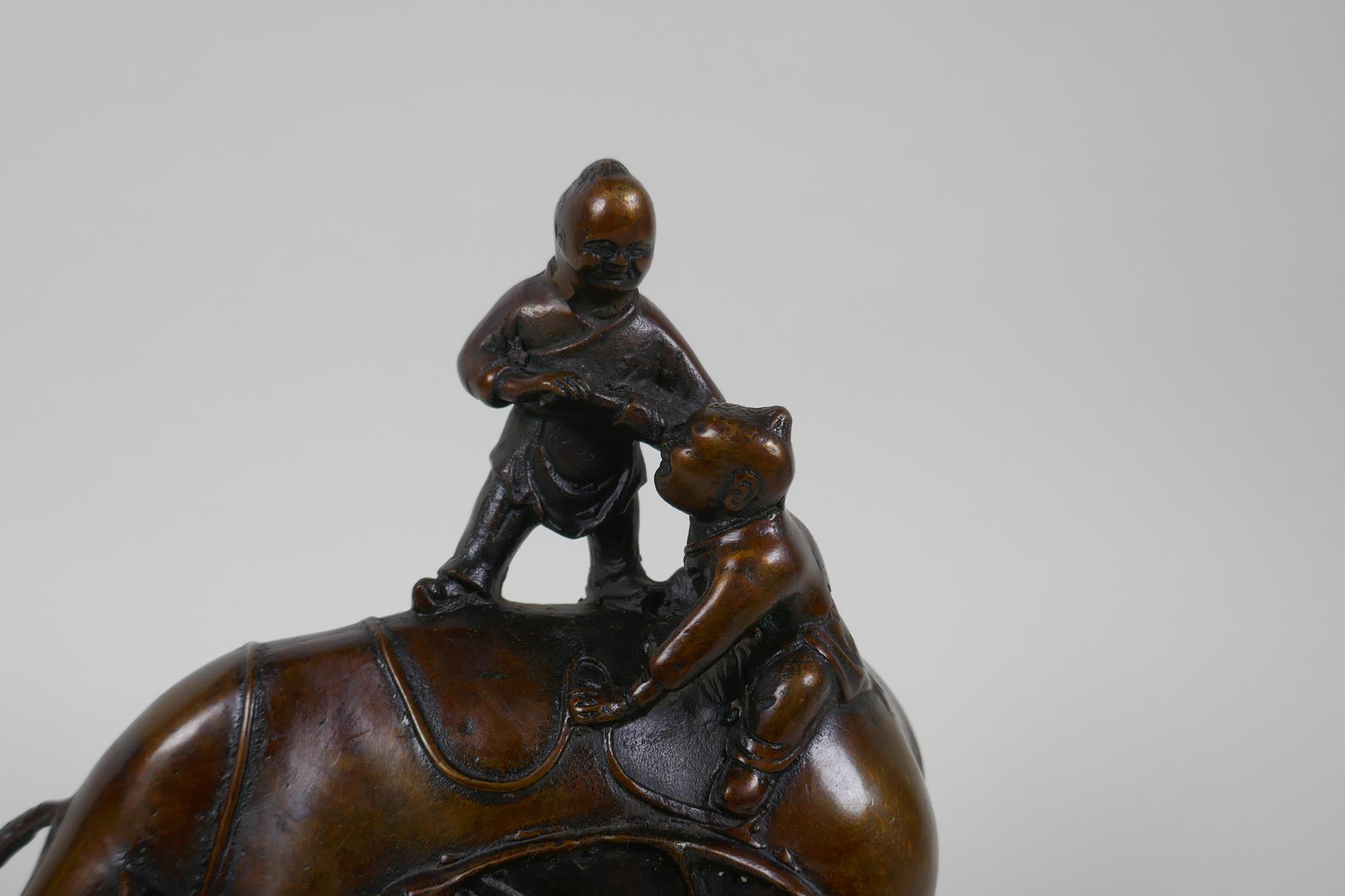 A Chinese filled bronze figure group of children playing on a buffalo, 18cm high - Image 3 of 4