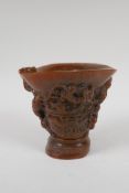 A Chinese faux horn libation cup decorated with climbing kylin, impressed seal mark to base, 14cm