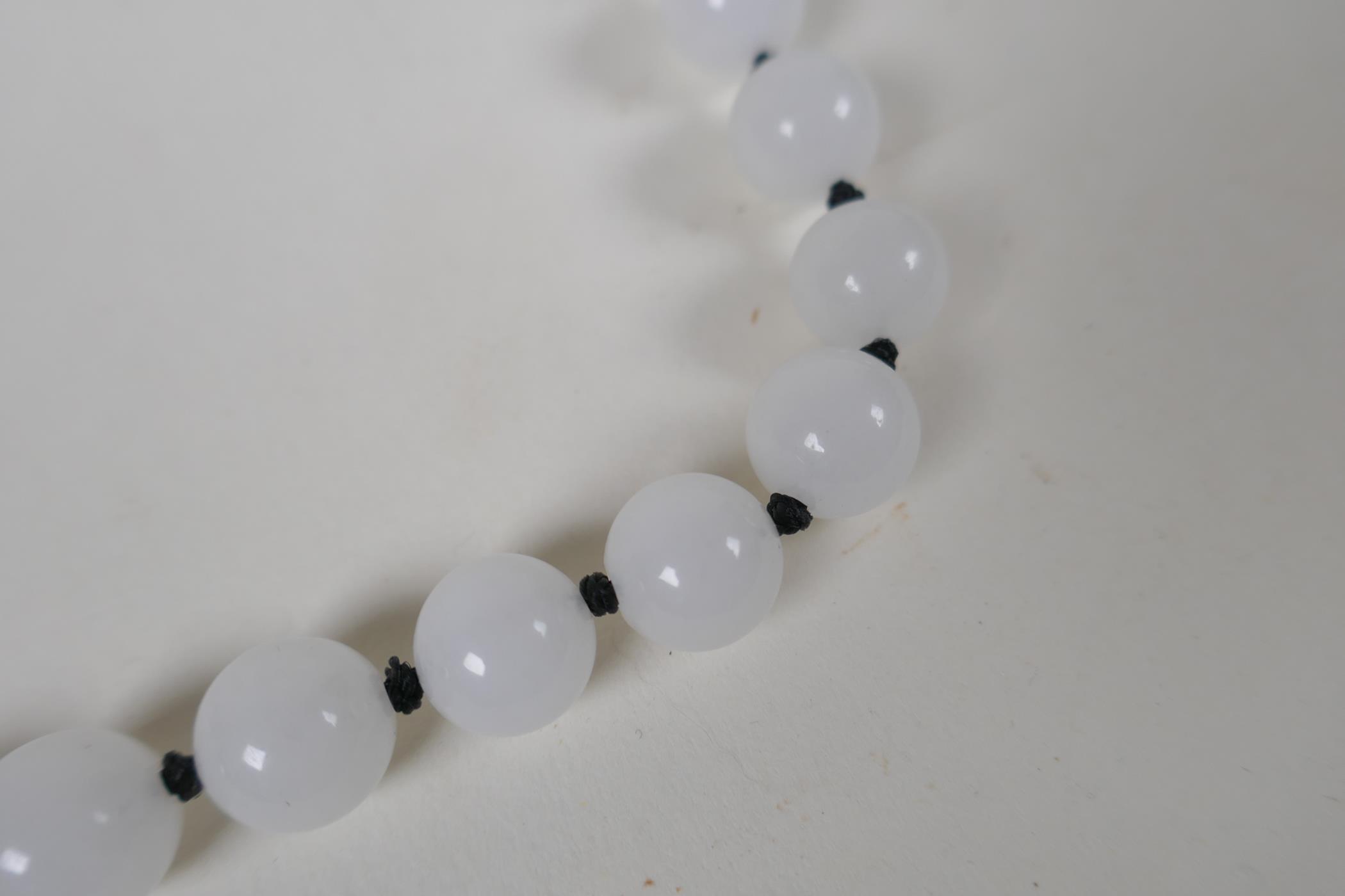 An apple green jade beaded necklace, together with a similar white jade beaded necklace, 70cm long - Image 2 of 4