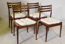 A set of four mid century mahogany dining chairs with squab cushions