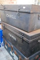 A vintage metal strapped travel trunk and two tin trunks of a similar size, 92 x 54cm, 36cm high