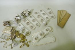 A quantity of brass and porcelain door furniture, finger plates 28cm long