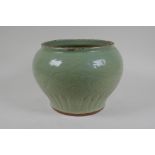 A Chinese Ming period (1369-1644) celadon glazed porcelain jar with incised lotus flower decoration,