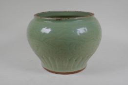 A Chinese Ming period (1369-1644) celadon glazed porcelain jar with incised lotus flower decoration,