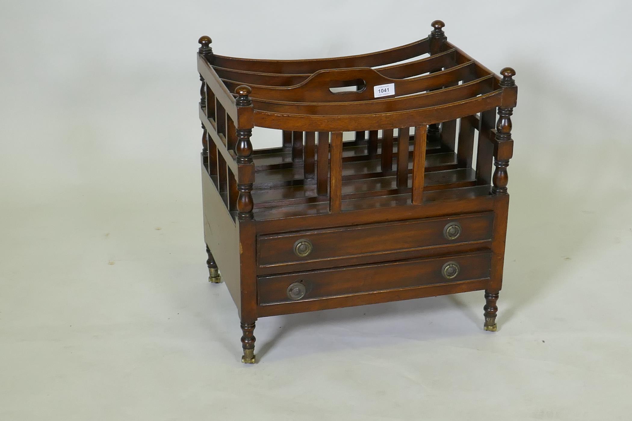 A C19th mahogany canterbury with two drawers, raised on turned supports with brass castors, 49 x