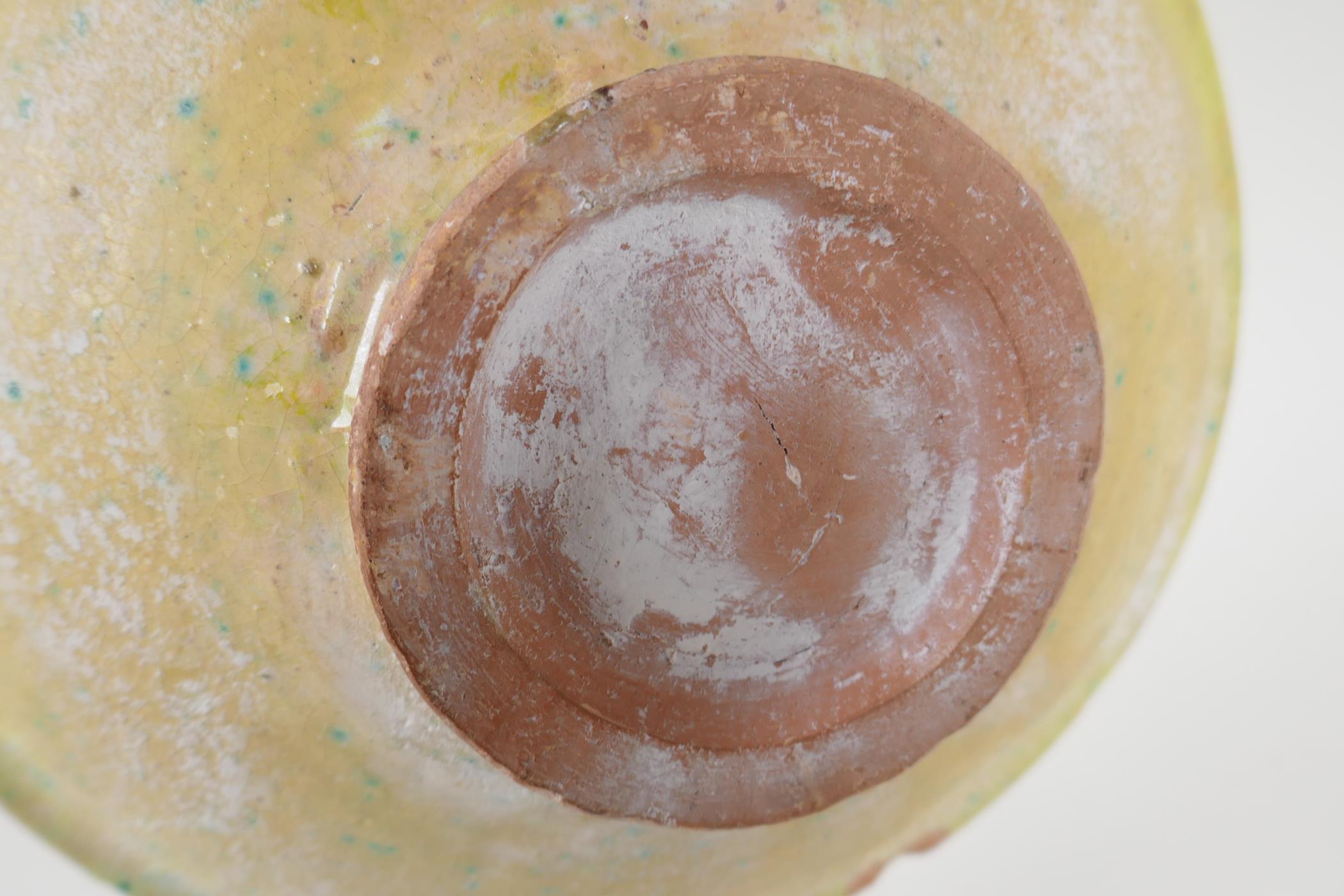 An antique Islamic pottery bowl decorated with birds and script, chips to glaze, 24cm diameter - Image 4 of 4