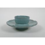 A Chinese celadon crackle ware stand of flower petal form, chased character marks, 16cm diameter