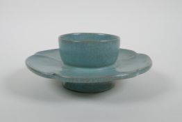 A Chinese celadon crackle ware stand of flower petal form, chased character marks, 16cm diameter