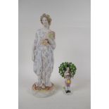 An antique Bisque figure of a lady gathering wheat, in hand painted floral clothing, together with