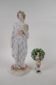 An antique Bisque figure of a lady gathering wheat, in hand painted floral clothing, together with