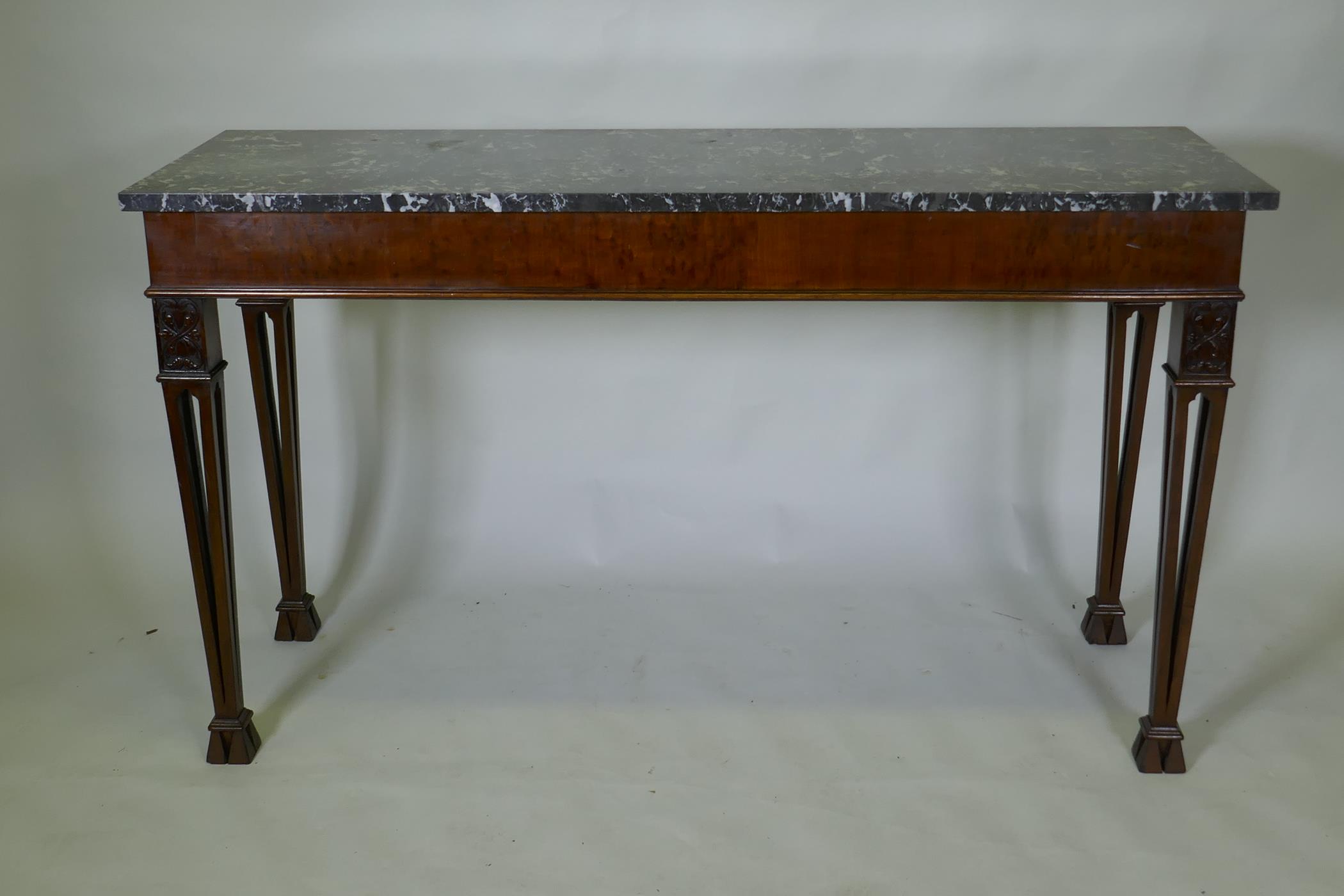 A mahogany Chippendale style serving table, with marble top and blind frieze, raised on pierced
