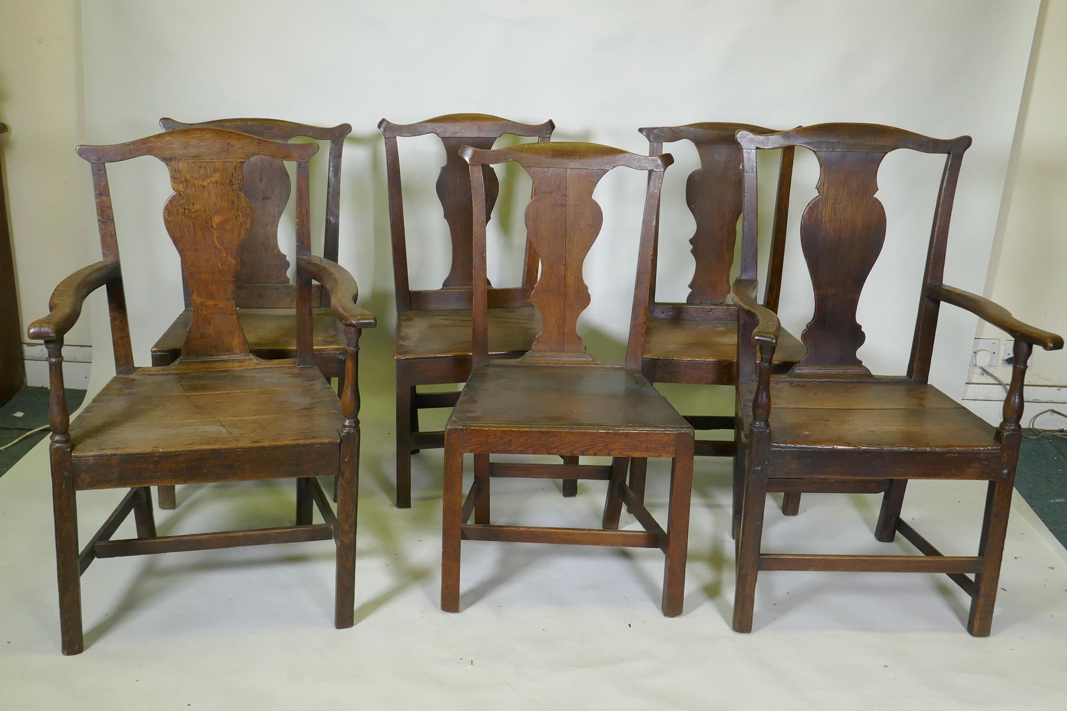 A set of six (4+2) provincial elm Chippendale style dining chairs with pegged joints and