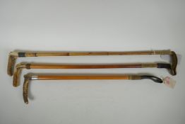 Three antique antler handled riding crops including one with a hallmarked silver cuff by J. Howell