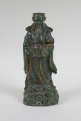 A Chinese moulded green glass figure of an immortal, 20cm high
